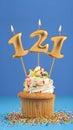Birthday cake with candle number 121 - Blue background