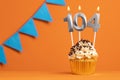 Candle number 104 - Cake birthday in orange background