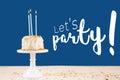 Birthday cake with candles on classic blue with Let`s party wording. Birthday party celebration concept Royalty Free Stock Photo