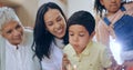 Birthday cake, child blowing candles and big family to celebrate with smile, fun and love together in home. Happiness Royalty Free Stock Photo