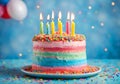 Colorful birthday cake with lit colored candles. Royalty Free Stock Photo