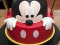 Birthday cake, decorated on a wood table. Mickey Mouse