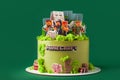 Birthday cake for a fan of Minecraft game on the green background. Cake for a gameboy decorated with edible green grass