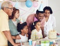 Birthday, cake and a girl blowing out candles while celebrating with her black family in their home. Kids, party or Royalty Free Stock Photo