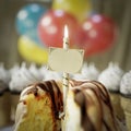 birthday cake with greeting card and candel conceptual close up photo Royalty Free Stock Photo