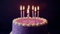 Birthday cake with lit candles on table Royalty Free Stock Photo