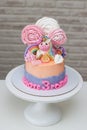 Birthday cake for a little girl with cute fondant fondant unicorn, flowers and rainbow
