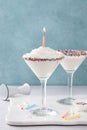 Birthday cake martini cocktail topped with whipped cream and a candle Royalty Free Stock Photo