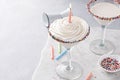 Birthday cake martini cocktail topped with whipped cream and a candle Royalty Free Stock Photo