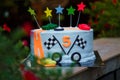 Birthday cake with mastic stars and cars figures for boy.
