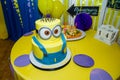 Birthday cake in minion shape. Cartoon character cake for child party. Thematic event. Candy bar