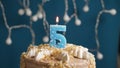 Birthday cake with 5 number candle on blue backgraund