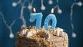 Birthday cake with 70 number candle on blue backgraund