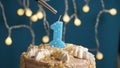 Birthday cake with 1 number candle on blue backgraund. Candles are set on fire