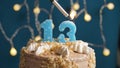 Birthday cake with 13 number candle on blue backgraund. Candles are set on fire