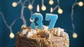 Birthday cake with 37 number candle on blue backgraund