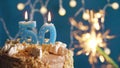 Birthday cake with 50 number candle and sparkler on blue backgraund