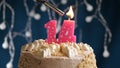 Birthday cake with 14 number pink candle on blue backgraund. Candles are set on fire Royalty Free Stock Photo