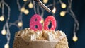 Birthday cake with 60 number pink candle on blue backgraund. Candles are set on fire Royalty Free Stock Photo