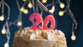 Birthday cake with 20 number pink candle on blue backgraund. Candles are set on fire Royalty Free Stock Photo