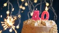 Birthday cake with 40 number pink candle and sparkler on blue backgraund Royalty Free Stock Photo