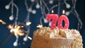 Birthday cake with 70 number pink candle and sparkler on blue backgraund Royalty Free Stock Photo