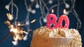 Birthday cake with 80 number pink candle and sparkler on blue backgraund Royalty Free Stock Photo