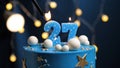 Birthday cake number 27 stars sky and moon concept, blue candle is fire by lighter. Copy space on right side of screen. Close-up Royalty Free Stock Photo