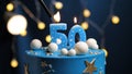 Birthday cake number 50 stars sky and moon concept, blue candle is fire by lighter. Copy space on right side of screen. Close-up Royalty Free Stock Photo