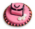 Birthday cake with pink frosting,decorated handbag Royalty Free Stock Photo