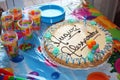 Birthday Cake on a table with plastic plates and glasses Royalty Free Stock Photo