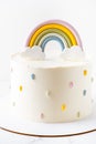 Birthday cake with white cream cheese frosting decorated with colorful mastic rainbow Royalty Free Stock Photo