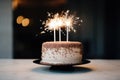 a birthday cake on a white plate with a sparkler on the side Royalty Free Stock Photo