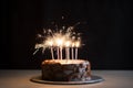 a birthday cake on a white plate with a sparkler on the side Royalty Free Stock Photo