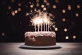 a birthday cake on a white plate with a sparkler on the side Royalty Free Stock Photo