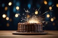 a birthday cake on a white plate with a sparkler on the side Royalty Free Stock Photo