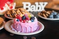 Birthday cakes and muffins with wooden greeting signs on rustic background. Wooden sing Baby and holiday sweets. Royalty Free Stock Photo