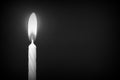 Birthday candle against a dark background close-up. Black and white Royalty Free Stock Photo