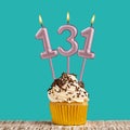 Birthday card with number 131 candle on aquamarine background