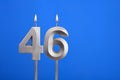 Birthday candle number 46 - Celebration card on blue background