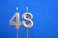 Birthday candle number 48 - Celebration card on blue background