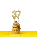 Birthday candle number 37 - Cupcake on white background