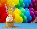 Birthday candle number 129 - Invitation card with balloons in colors of the gay pride march Royalty Free Stock Photo
