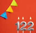 Birthday candle number 122 - Invitation card in orange background