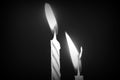 Birthday candles against a dark background close-up. Black and white