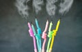 Birthday candles with flame blown out smoke on dark background Royalty Free Stock Photo