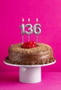 Birthday card with candle number 136 - Chocolate cake on pink background