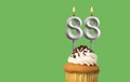 Birthday with number 88 candle and cupcake - Anniversary card on green color background