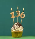 Birthday candle number 136 - Vertical anniversary card with green background