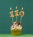 Birthday card with candle number 119 - Green background Royalty Free Stock Photo